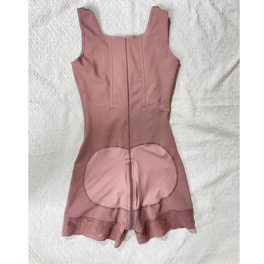 Rose bodysuit laid flat from the back showing vertical stays, a seat panel and lace trim at the leg openings