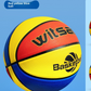 Red yellow and blue paneled kids basketball shown close up on a blue studio block