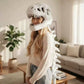The dinosaur skeleton plush hood shown on a plain background