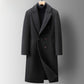 Charcoal black double-breasted long coat with wide lapels and two rows of buttons, front view on a grey background
