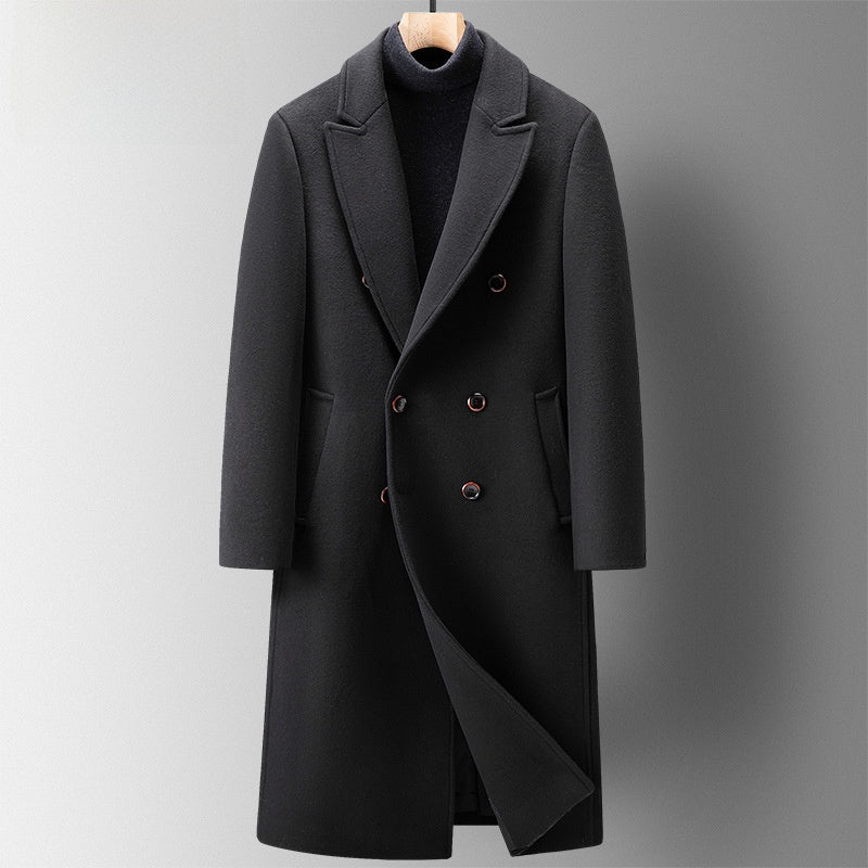 Charcoal black double-breasted long coat with wide lapels and two rows of buttons, front view on a grey background