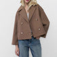 White cropped double breasted wool blend coat buttoned with notch lapels on a model