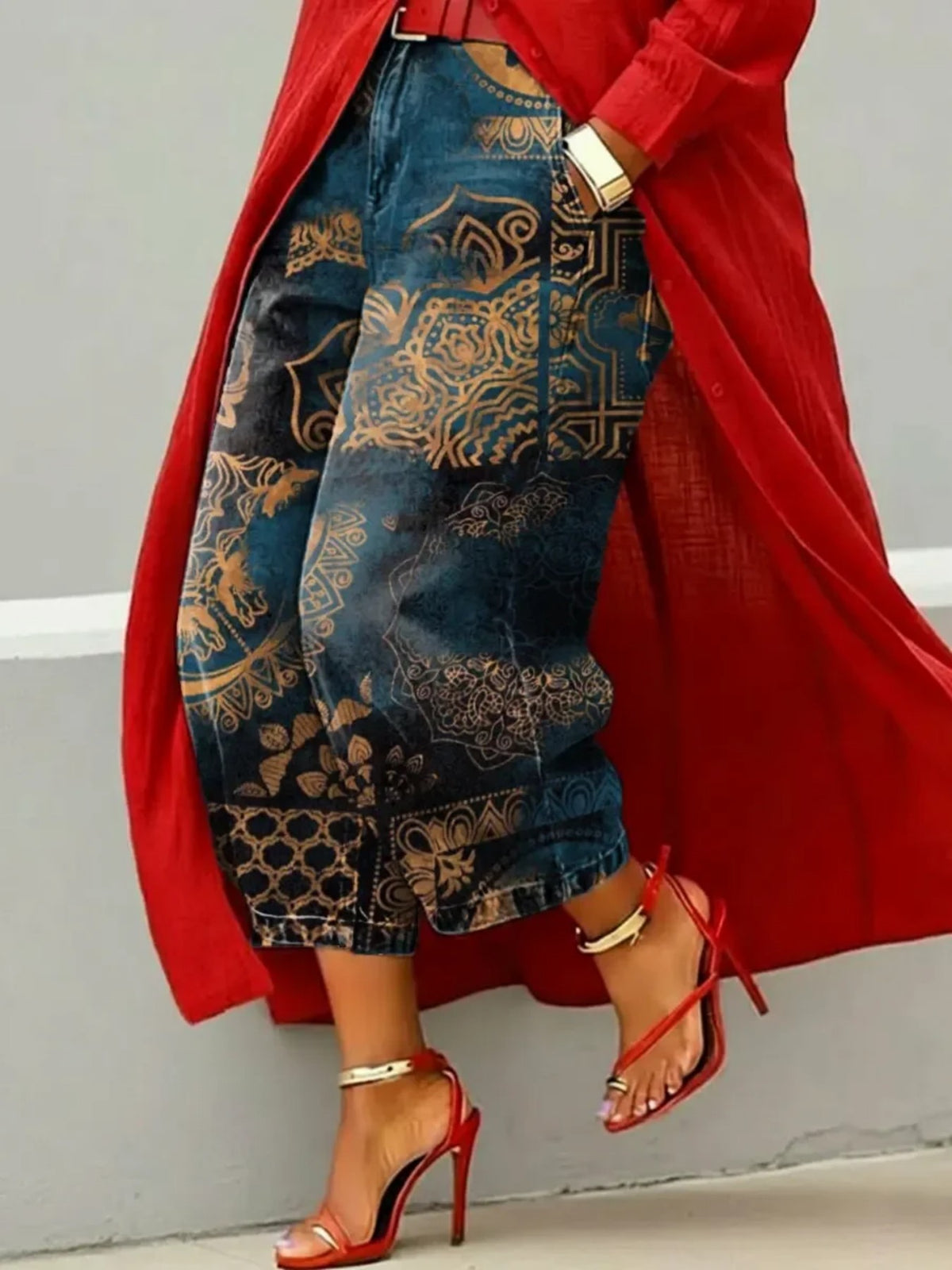 Wide leg cropped deep teal denim jeans with gold ornate medallion print, red coat and heels