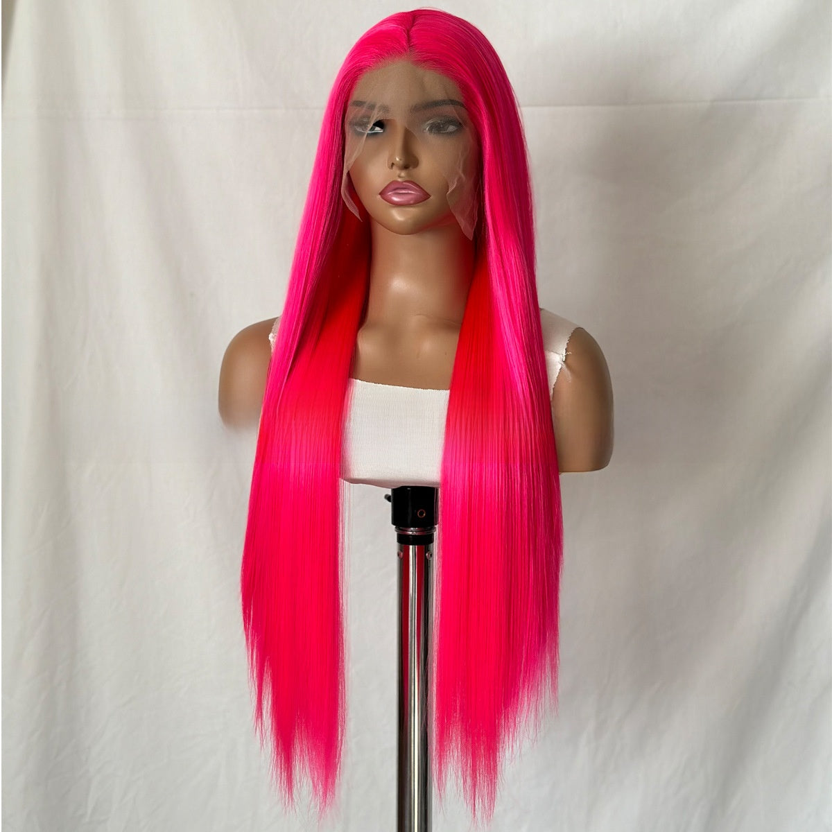 Long straight rose pink lace front wig on a mannequin head, front view with a center part
