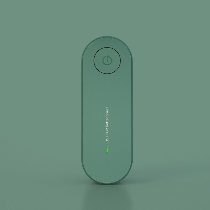 Green flat oval ion generator standing upright against a matching green background
