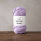 Light purple and navy merino wool yarn balls for hand knitting
