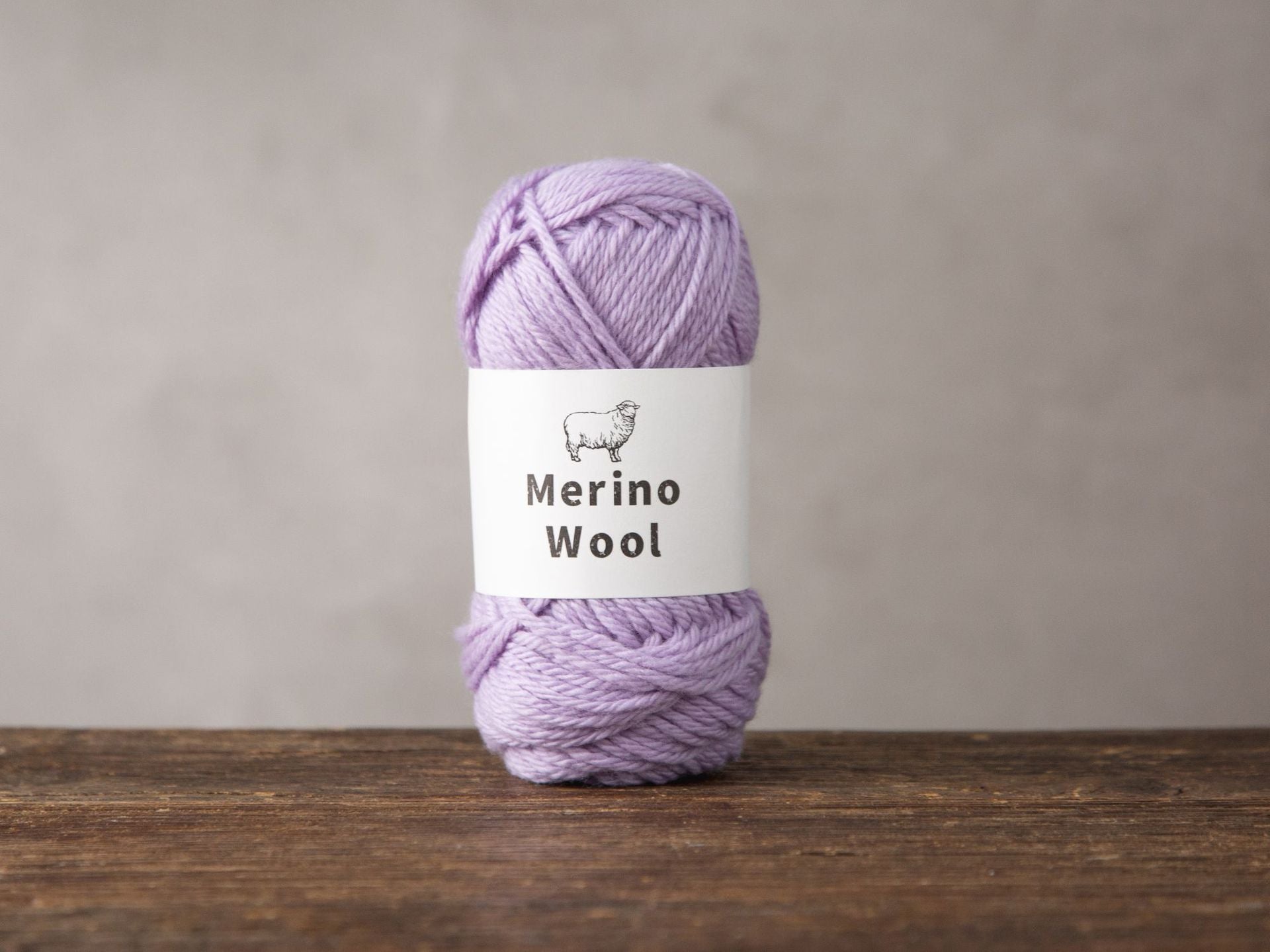 Light purple and navy merino wool yarn balls for hand knitting