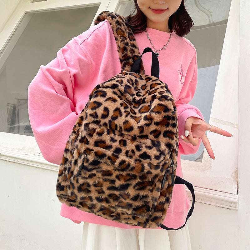 Full size plush leopard print faux fur backpack shown from the front with top zip