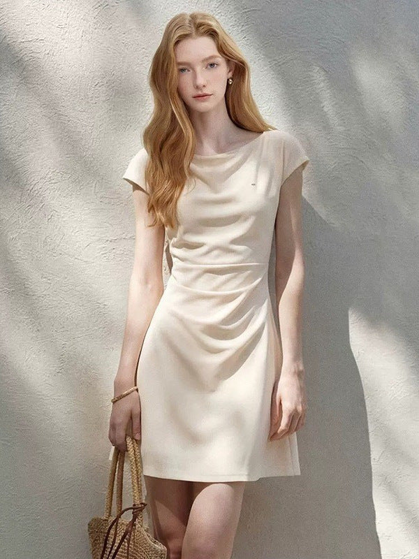 A-line cap sleeve ruched waist mini dress in soft stretch knit, front view on a standing model
