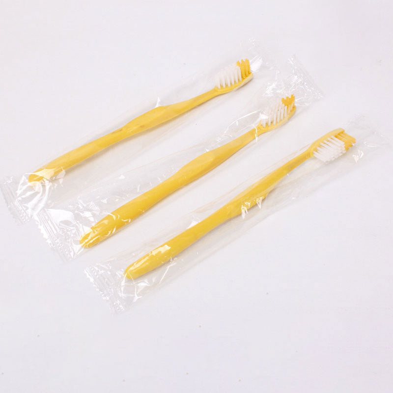 Disposable travel toothbrush and toothpaste set shown with its sealed dental kit pouch