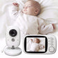 White baby monitor camera and 3.2 inch handheld parent unit showing a sleeping baby on a bed