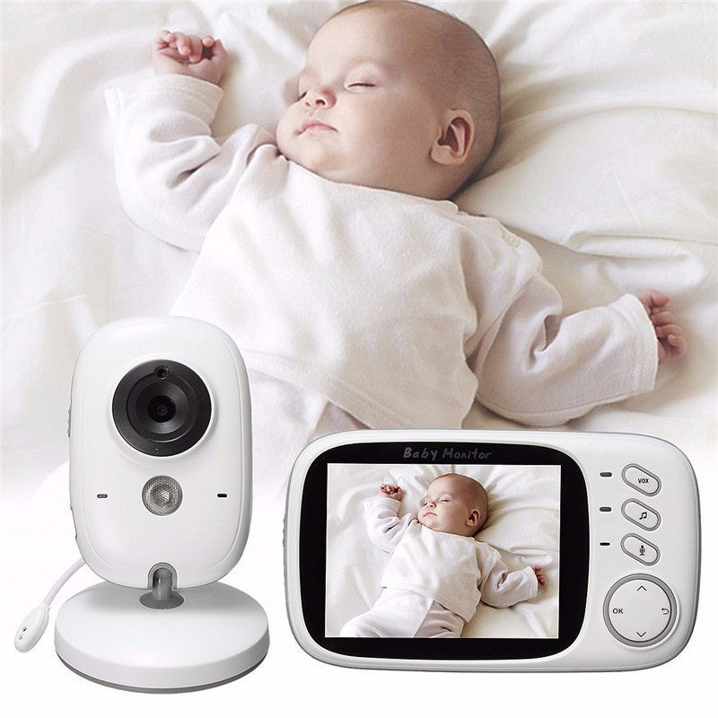 White baby monitor camera and 3.2 inch handheld parent unit showing a sleeping baby on a bed