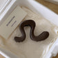 Glossy wavy acrylic claw clip for thick long hair shown in a cream gift box