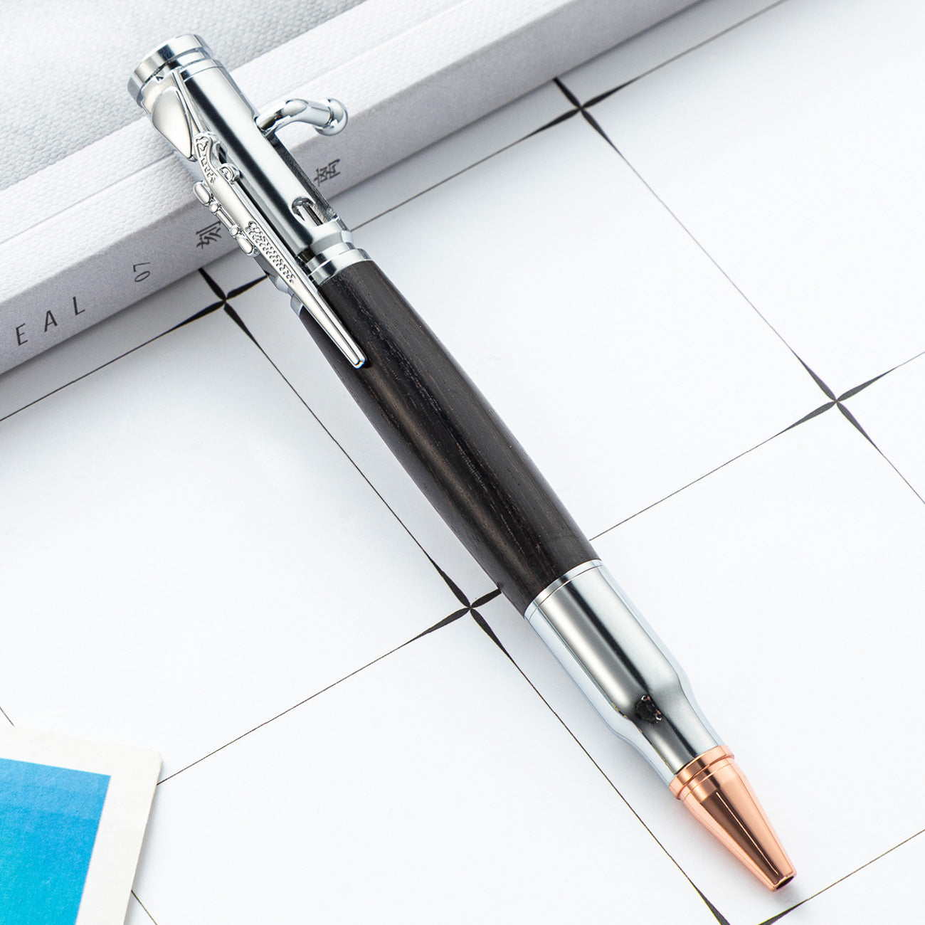 Bolt action ballpoint pen with rifle style bolt lever and wood barrel on a white background