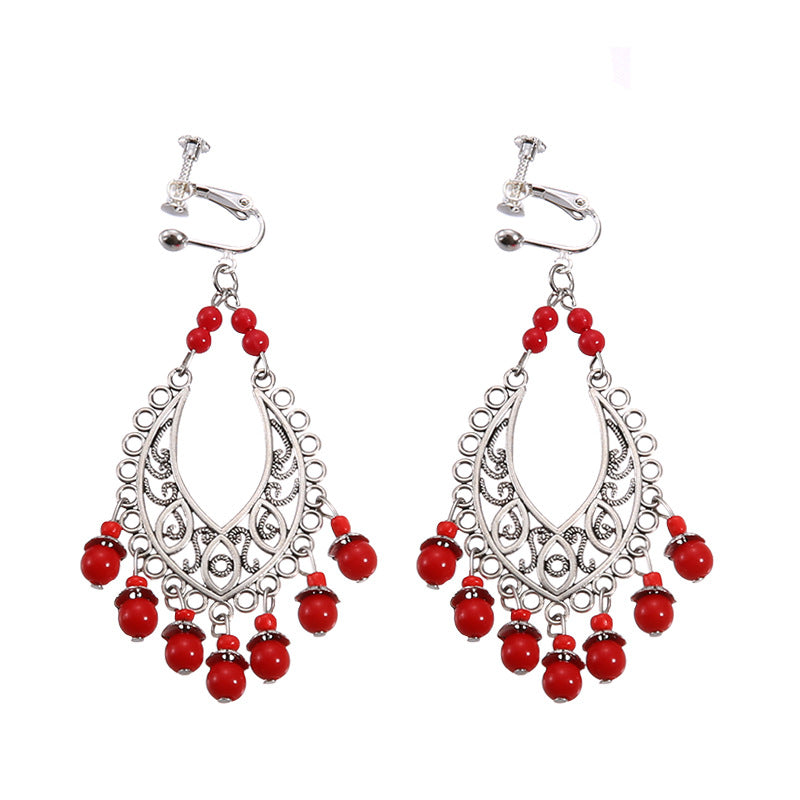 Bohemian vintage clip-on tassel drop earrings on a zinc alloy frame, handmade boho pair on white studio background