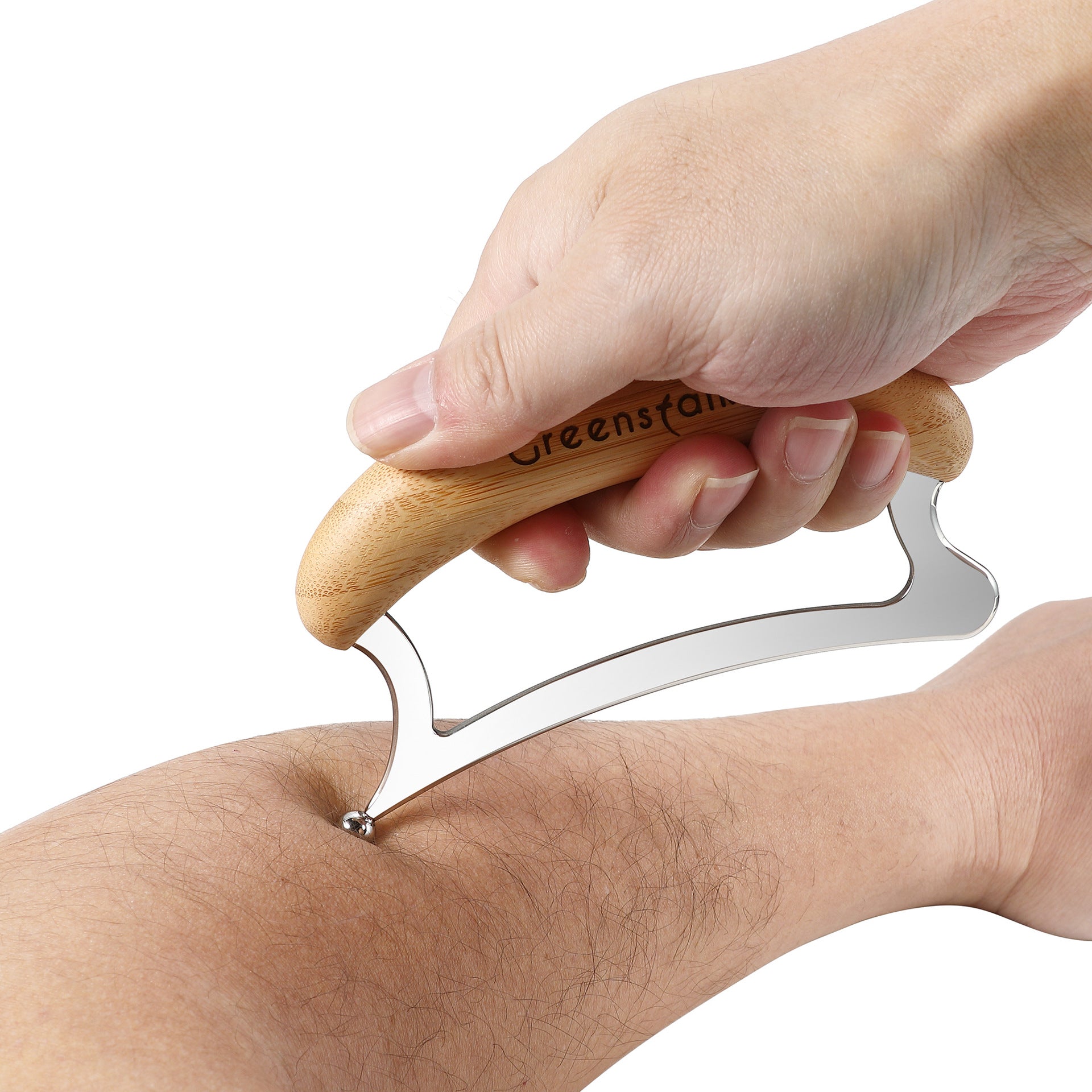 Gua sha scraping tool drawn along a forearm showing the steel edge in use