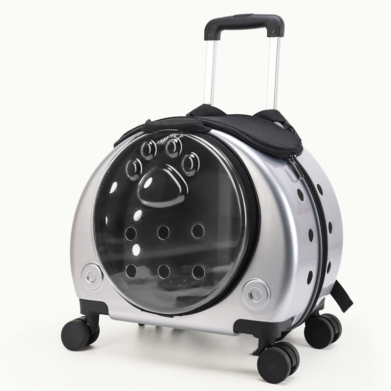 Silver rolling pet carrier with a dark bubble window, ventilation holes, pull rod and four swivel wheels