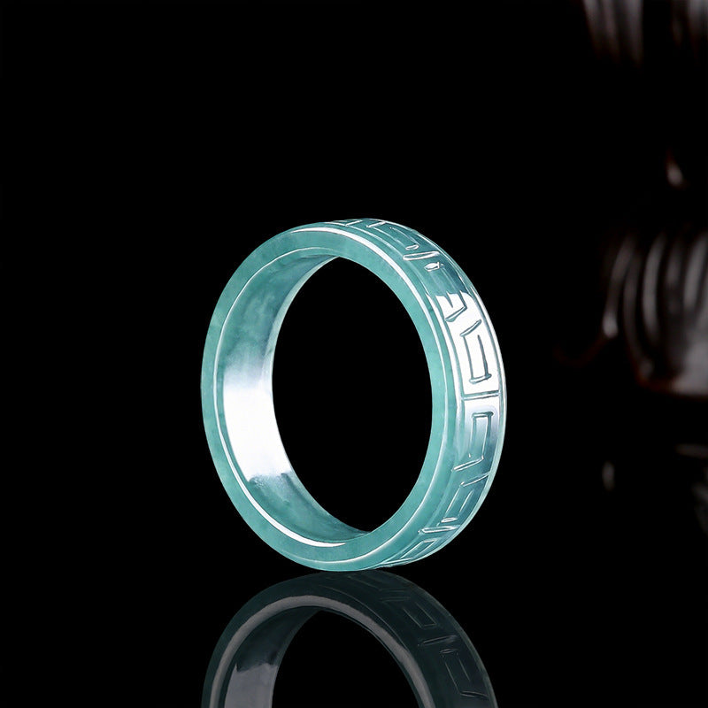 Blue water jadeite ring on a black ground showing the polished squared band