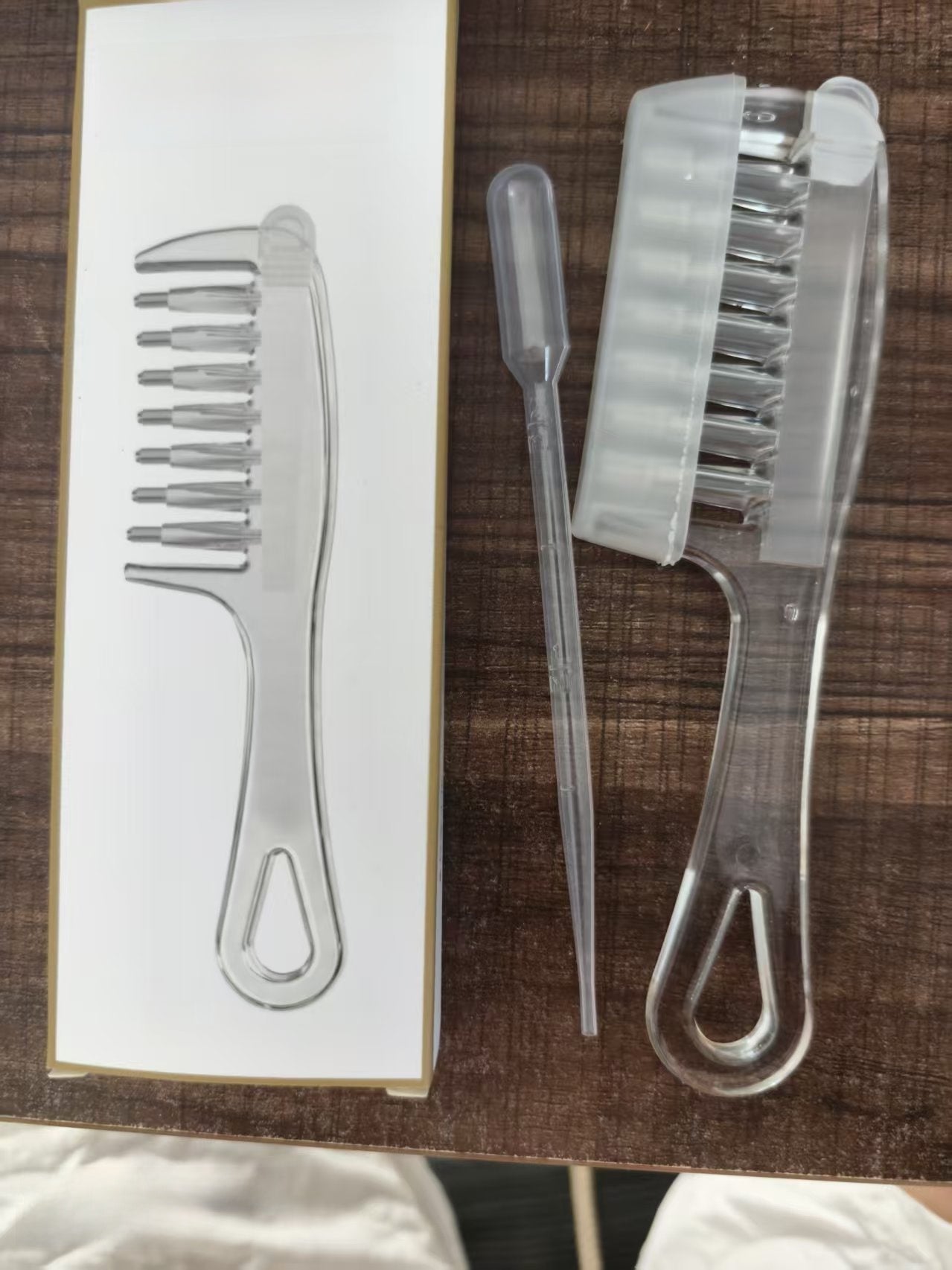 Seven tooth transparent comb with teardrop cutout style for finer hair and even spreading