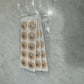 Sheets of adhesive magnetic nasal patches and packaging shown in an overview layout