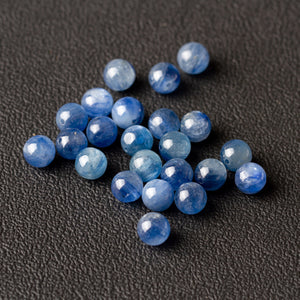 Strand of polished blue kyanite gemstone beads with a silky chatoyant streak