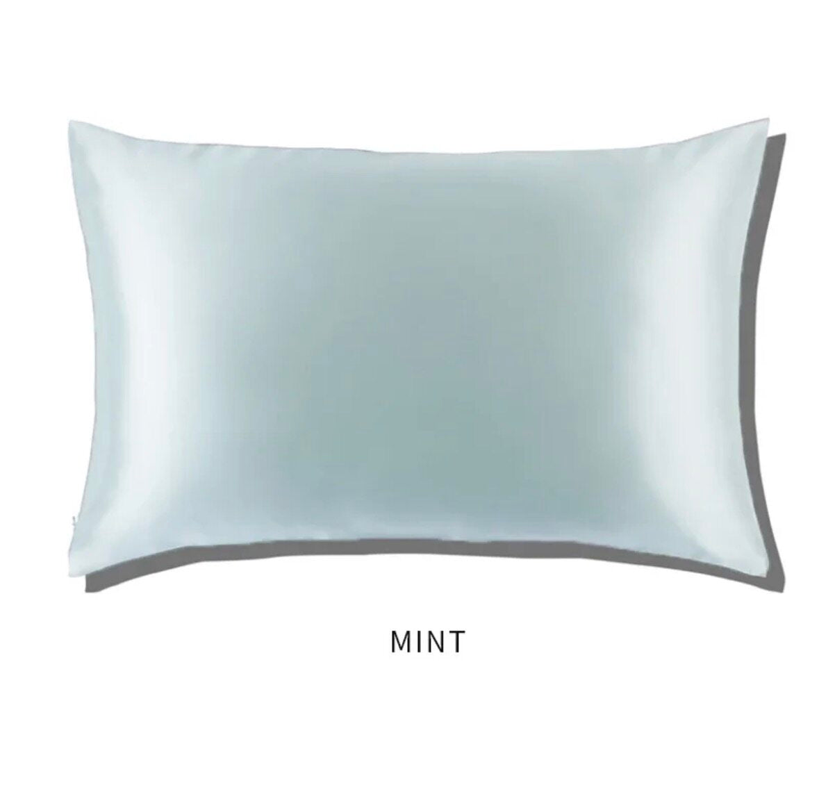 Light mint slip glossy silk pillowcase on a white background