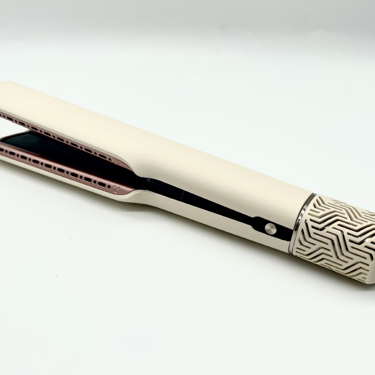 Close view of hair straightener rose gold vented plates and geometric etched cap