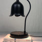 Halogen bulb warming a jar candle from above with no flame