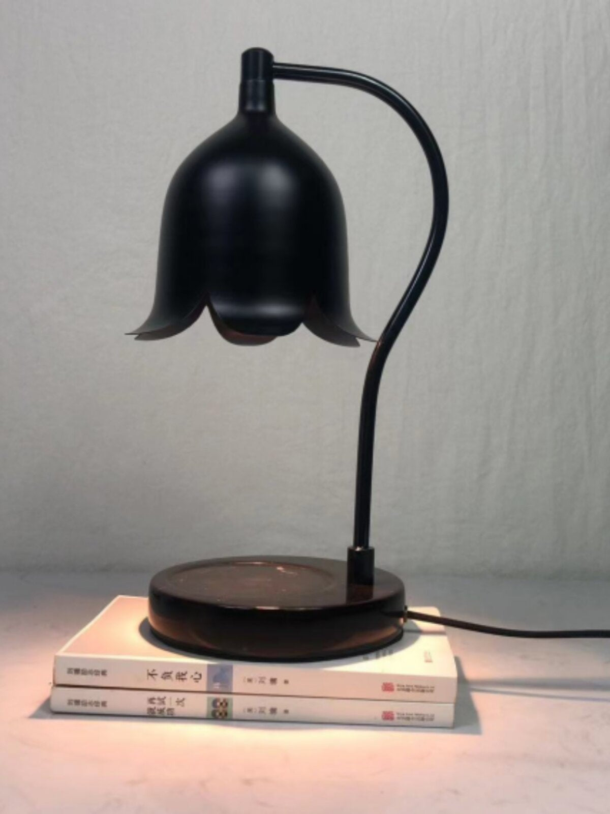Halogen bulb warming a jar candle from above with no flame