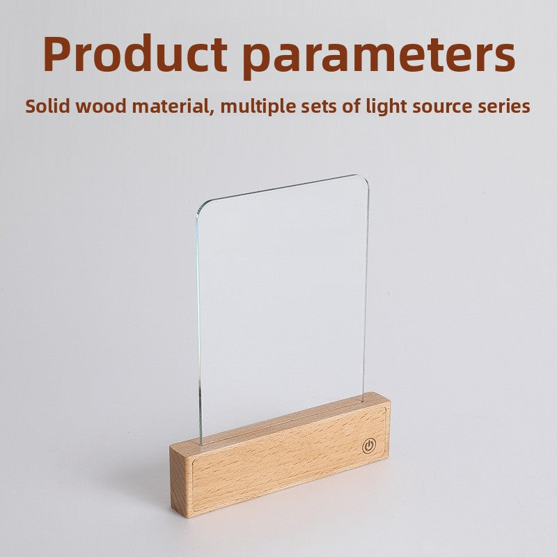 Close view of the solid beech wood base and touch pad of the reading lamp on a book