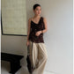 Woman in khaki wide leg linen blend trousers with a brown top full length view