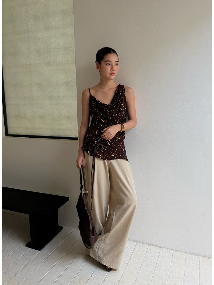 Woman in khaki wide leg linen blend trousers with a brown top full length view