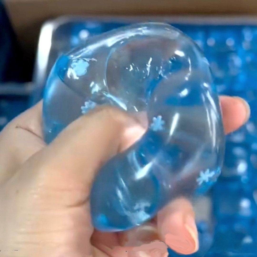 Blue gel snowflake cube squishy stretched long between two hands showing the flakes drifting inside