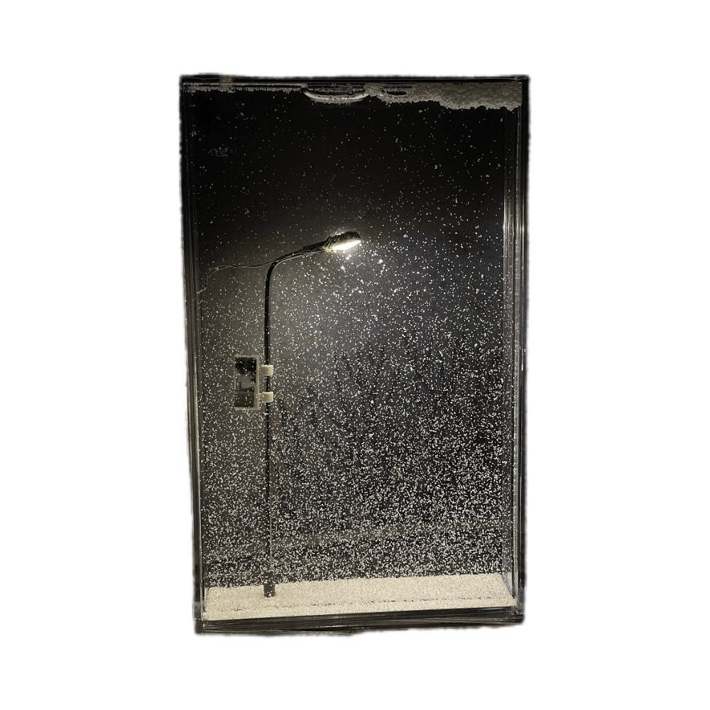 Clear acrylic Christmas light box with a slim LED street lamp glowing through fine faux snow flakes