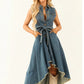 Sleeveless blue denim dress with adjustable waist tie, front view on plain studio background