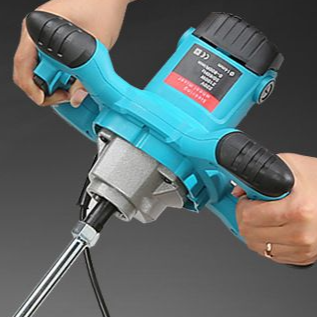 Two hands gripping the side handles of the corded handheld power mixer while mixing