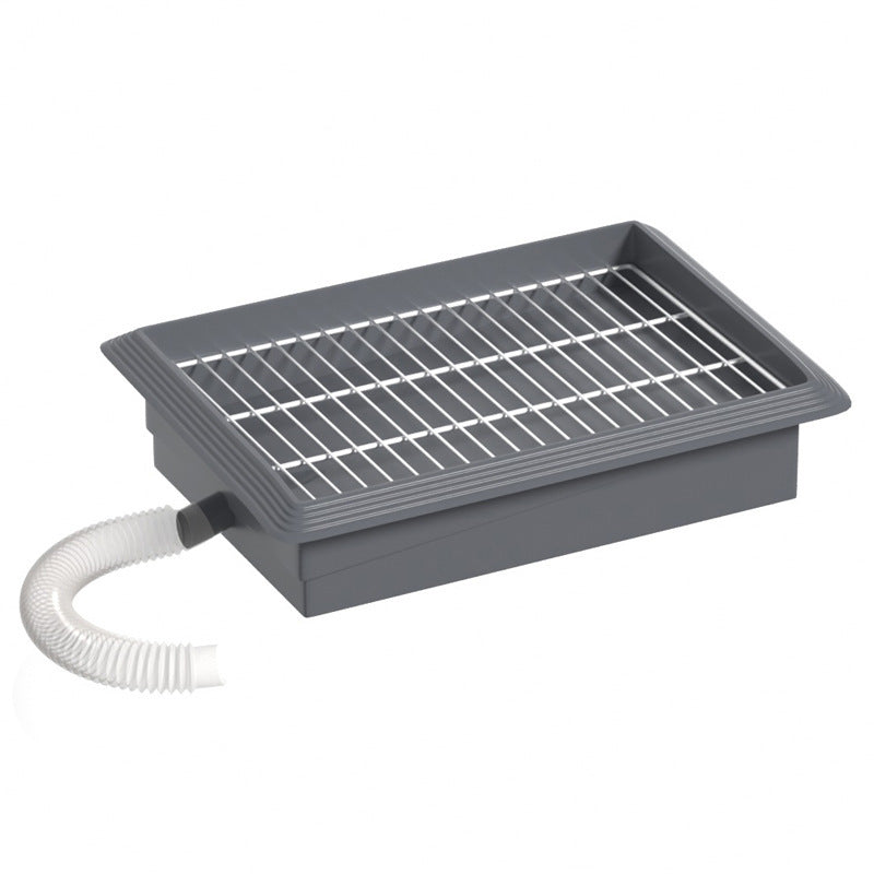 Detachable grid lifted off the grey dog potty tray base for rinsing and cleaning