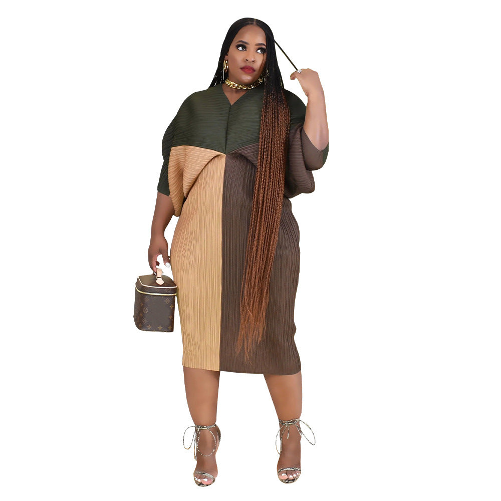 Pleated batwing midi dress with all over accordion pleats on a standing model, full length