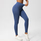 Steel blue high waist leggings pulled at the waistband to show the stretch, side view