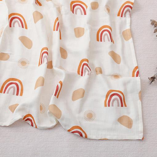 Pure cotton muslin swaddle blanket rolled up, showing the airy gauze texture and printed design