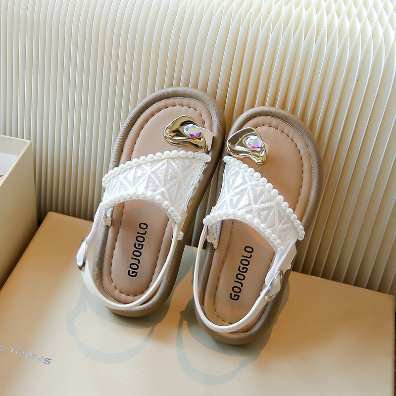 Girls' pearl sandals styled with a summer dress in champagne tone