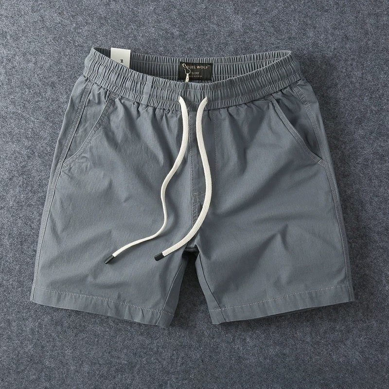 Grey men's cotton drawstring shorts showing the elastic drawstring waistband