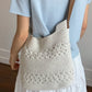 Off-white woven cotton crochet bag worn crossbody with brown strap