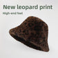 Brown leopard print plush bucket hat with a short brim on a white background