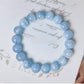 Top view of the blue bead bracelet showing white veining across the round polished stone beads