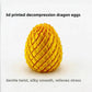 Metallic 3D printed dragon egg fidget toy held between finger and thumb