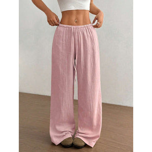High waist wide leg crinkle cotton trousers shown front on with an elastic drawstring waist