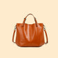 Cognac orange cowhide leather bucket tote with top handles and a shoulder strap, cognac option