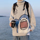 Light gray knitted shark turtleneck sweater against a seaside backdrop, size XXL option