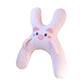 Gray dog shaped plush car nap pillow hanging on a car headrest